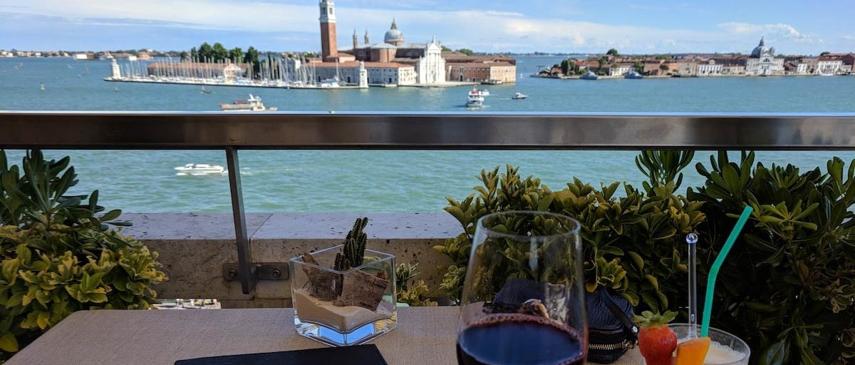 A magnificent view of the Grand Canal in Venice from the balcony of the famous Hotel Daneli, accompanied by some amazing wine and snacks.
